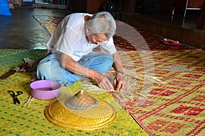 Old man of Shan working a hat handmade made of bamboo